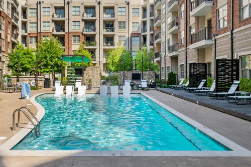 a swimming pool in an apartment complex with a building at Uptown 4th Ward Luxury Apt Year-Round Pool in Charlotte