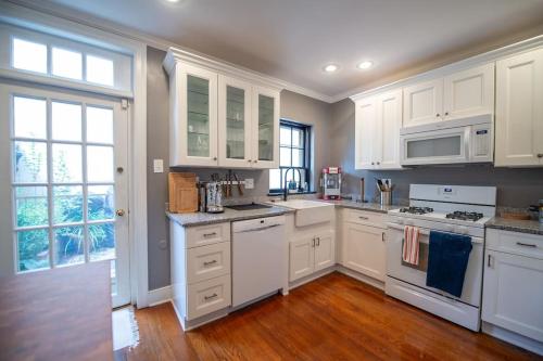 a kitchen with white cabinets and white appliances at Society Hill, Historical Luxury Home, 3Bd/2.5Ba in Philadelphia