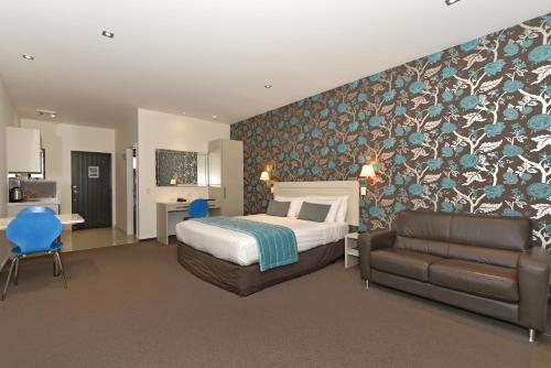 a hotel room with a bed and a couch at Aoraki Court Motel in Mount Cook Village