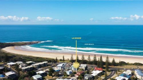an aerial view of a beach with houses and the ocean at La Ronde One - Unit 1 - oceanstays in Yamba