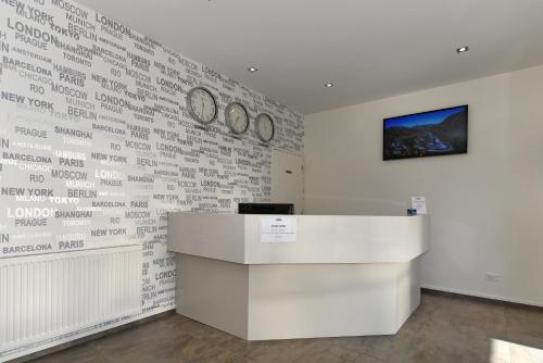 an office with a wall with clocks on it at Aoraki Court Motel in Mount Cook Village