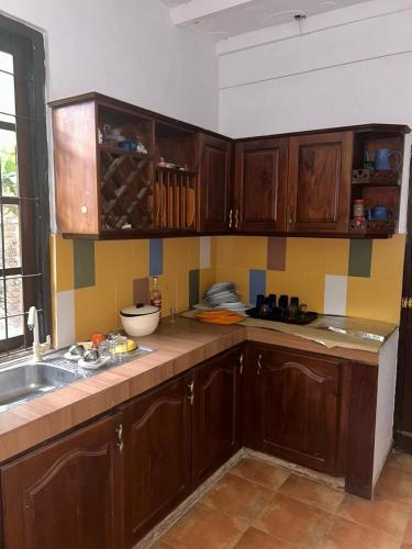 a kitchen with wooden cabinets and a sink at Keran villa in Wadduwa