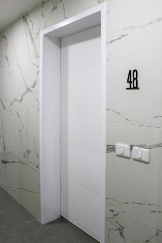 an elevator door with the number on the wall at Luxury Suite Apartment #48 By Hashdera Eilat in Eilat