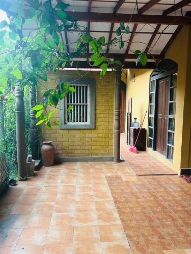 a patio in front of a house with a window at Keran villa in Wadduwa