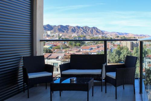 a balcony with chairs and a view of the mountains at Luxury Suite Apartment #48 By Hashdera Eilat in Eilat