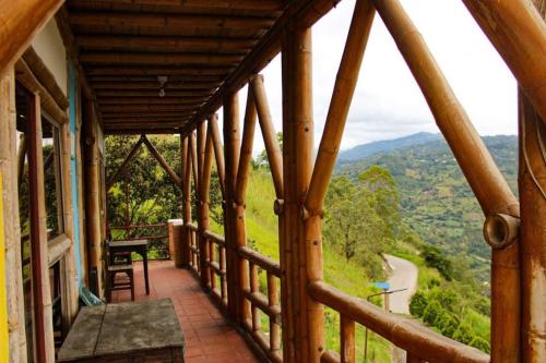 a balcony of a house with a view of a road at Hotel Campestre Mirador De San Nicolas in Ubaque