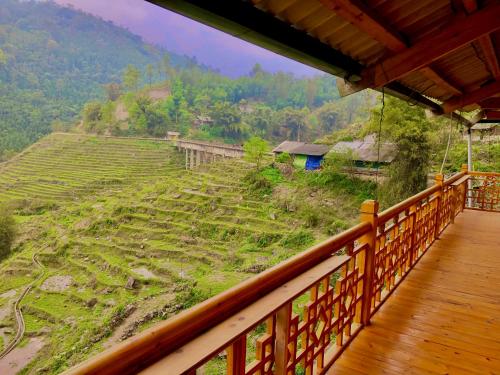 a balcony with a view of a rice field at Lysa House in Lao Cai