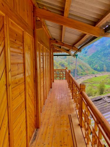 a wooden walkway in a cabin with a view at Lysa House in Lao Cai