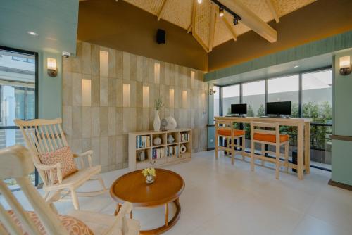 a living room with chairs and a table at Bhu Nga Thani Resort & Villas Railay in Railay Beach