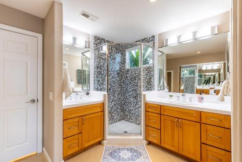 a bathroom with two sinks and a shower at Sumptuous Coastal Hideaway in Oceanside