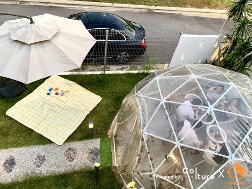 an iguana tent with a table and an umbrella at 30-80 pax Private Event Venue - Sunset Paradise by Cowidea in Masai