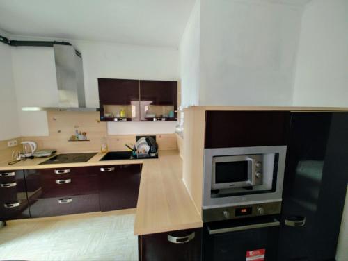 a kitchen with a microwave and a tv on a counter at The ARK Eco Homestay in Esch-sur-Alzette