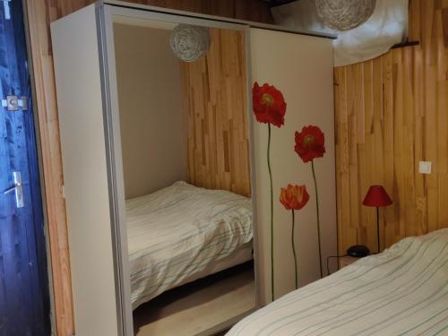 un miroir reflétant une chambre avec un lit et un lit dans l'établissement Appartement Les Gets, 1 pièce, 4 personnes - FR-1-671-257, aux Gets