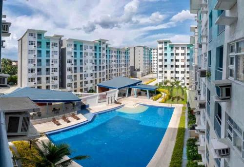 an aerial view of an apartment complex with a swimming pool at Micairan Suite in Davao City