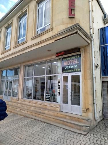 a store front of a building with a sign on it at Quba ALFA-M Motel in Quba