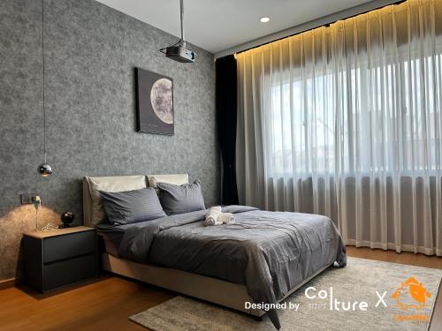 a bedroom with a bed and a large window at JB Weekend Escape - Mount Austin by Cowidea in Johor Bahru