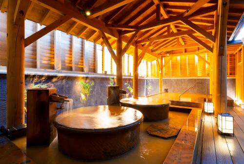 a bathroom with two large tubs in a building at OMO5 Hakodate by Hoshino Resorts in Hakodate