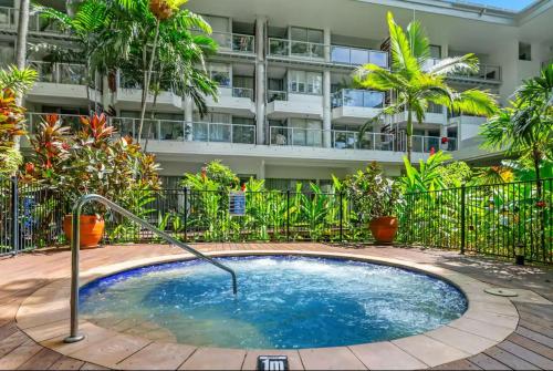 a small pool in front of a building at Palm Cove Beachside Apartments - Sea and Mountain Views in Palm Cove