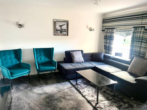 uma sala de estar com um sofá e duas cadeiras em Lovely 3 Bed Home In Glasgow with FREE Parking em Glasgow