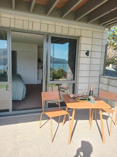 a table and two chairs on a patio with a view at The Views in Dunedin