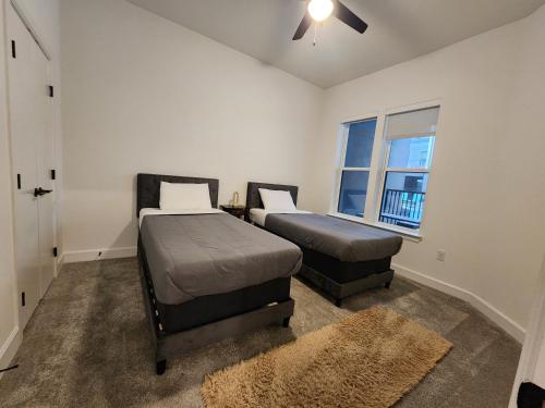 a bedroom with two beds and a window at Château at Lake Austin - 10 Min Walk to Center DT in Austin