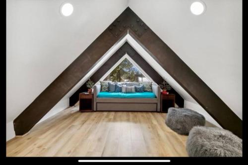 a bedroom with a bed in a triangle shaped room at Tahoe Haven: Your Retreat Awaits in Incline Village
