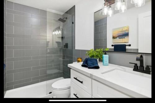 a bathroom with a sink and a toilet and a mirror at Tahoe Haven: Your Retreat Awaits in Incline Village