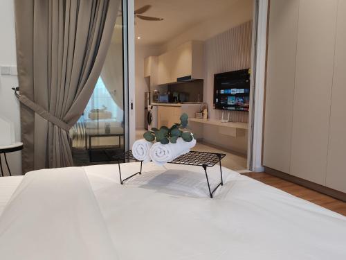 a bedroom with a large white bed with a table at Quill Residence KLCC By Ezhome in Kuala Lumpur