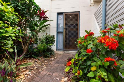 a front door of a house with flowers at Driftwood on the Beach in Yeppoon
