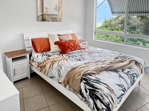 a large bed in a room with a window at Welcome Homestay Bayside in Larrakeyah