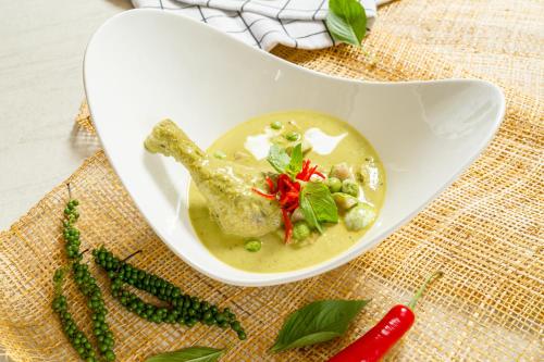 a white bowl filled with soup on a table at Bhu Nga Thani Resort & Villas Railay in Railay Beach