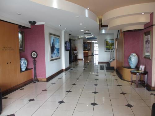a hallway of a building with a tile floor at Springwood Tower Apartment Hotel in Springwood