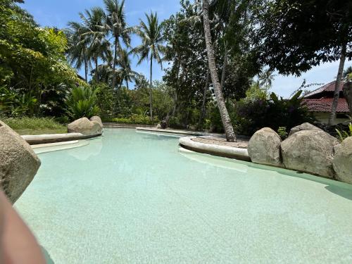 a swimming pool with blue water in a resort at Nongsa Village Peaceful Villa in private beach Resort in Nongsa
