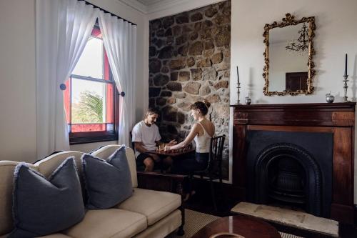 a man and a woman playing a game in a living room at Eagles Nest Milton in Milton
