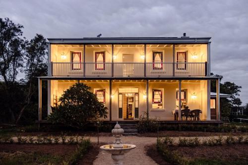 a large white house with a balcony at Eagles Nest Milton in Milton