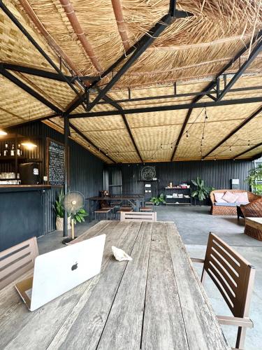 an office with a wooden table with a laptop on it at Dayon Hostel in Coron