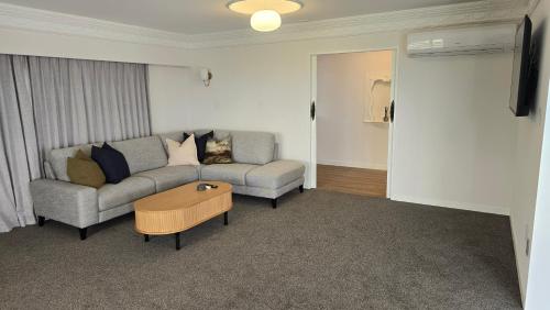 a living room with a couch and a coffee table at Grandpa’s Place in Te Aroha