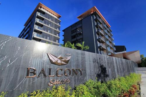 a sign for a biloxi hotel with two tall buildings at Balcony Seaside Sriracha Hotel & Serviced Apartments in Si Racha