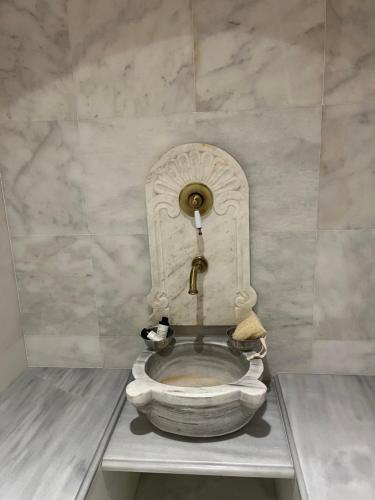 a statue of a toilet in a room at MONOVASIA SUITES Tholos Hammam in Monemvasia