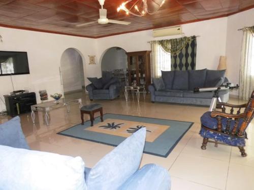 a living room with couches and a table and a couch at Kukunjang in Banjul