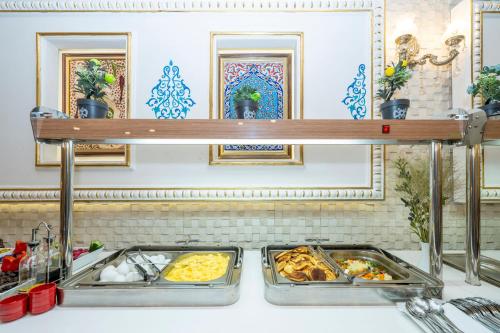 a buffet with two trays of food on a counter at The Byzantium Suites Hotel & Spa in Istanbul