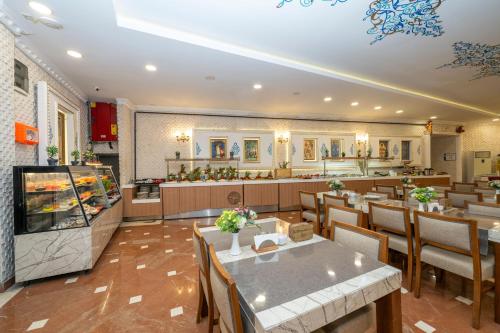 a restaurant with tables and chairs and a counter at The Byzantium Suites Hotel & Spa in Istanbul