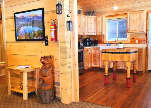 a kitchen with wooden cabinets and a table in a cabin at Sequoia Splendor, inside Kings Canyon NP by Visitors Center in Wilsonia