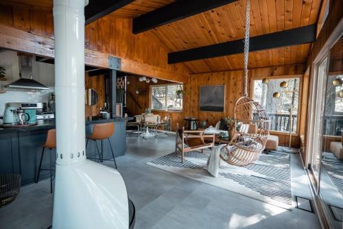 a kitchen and living room with a swing at Mid-Century Cabin Perfect for Romantic Getaway in Running Springs
