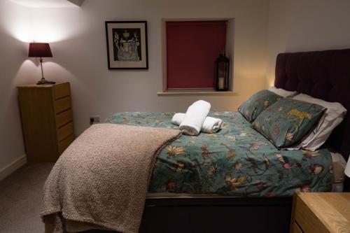 a bedroom with a bed with a stuffed animal on it at 2 Riverside in Barnard Castle