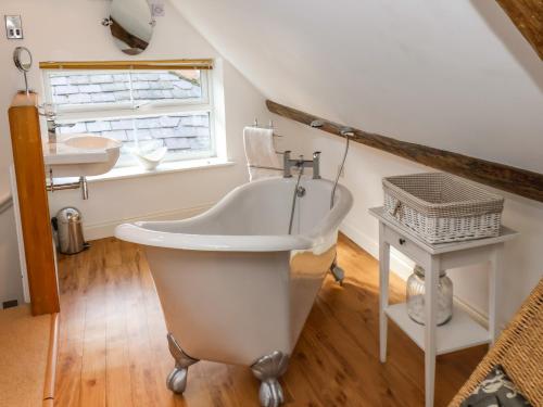 a bathroom with a claw foot tub and a sink at Sea Shanty in Whitby