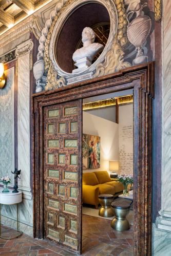 a large mirror in a room with a yellow couch at Gandesa, Palace House in Seville