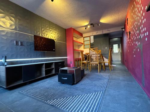 a living room with a stove and a dining room at Contemporary style house. in Mexico City