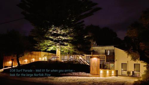 a sign in front of a building at night at Peaceful Places - Surf Side, Linen, Pets, Wifi in Inverloch
