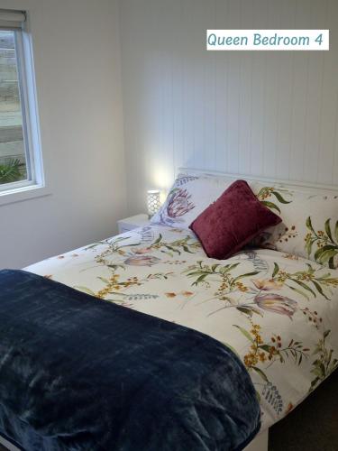 a bedroom with a bed with a flower pattern on it at Peaceful Places - Surf Side, Linen, Pets, Wifi in Inverloch